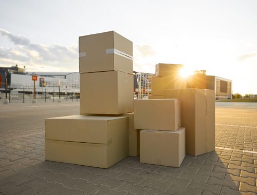 Parcel cardboard boxes stack on street city waiting for professional house moving and delivery service